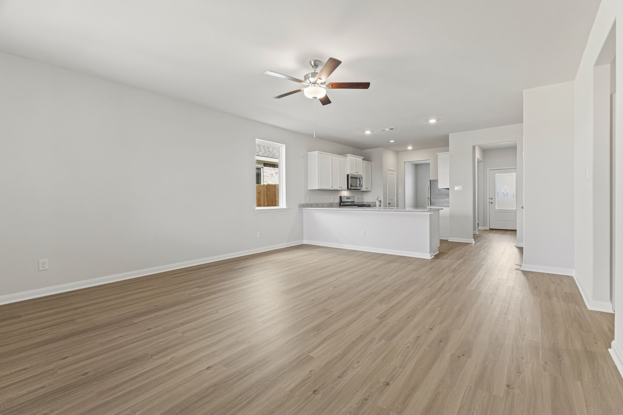 8946 Ice Quartz Drive Iowa Colony, TX 77583 - Photo 10 of 15 a view of a kitchen with a stove cabinets and wooden floor