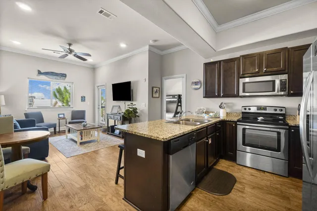 a kitchen with granite countertop a sink and cabinets