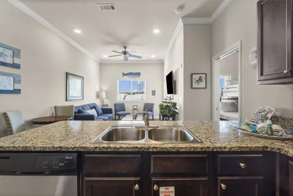 a kitchen with granite countertop a sink and a stove