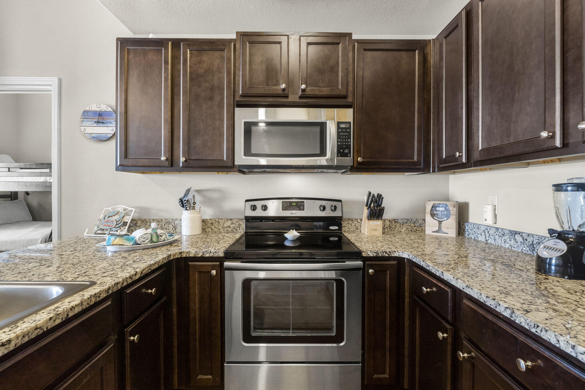 732 Scenic Gulf Drive, Unit E304 Destin, FL 32550 - Photo 14 of 34 a kitchen with granite countertop a sink and a stove