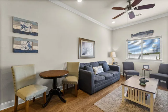 a living room with furniture a rug and a window