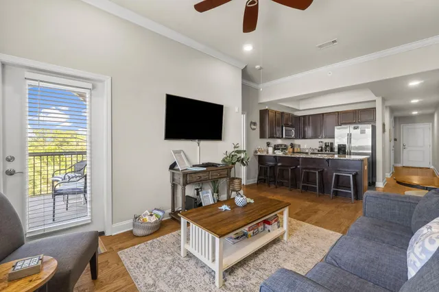 a living room with furniture and a dining table