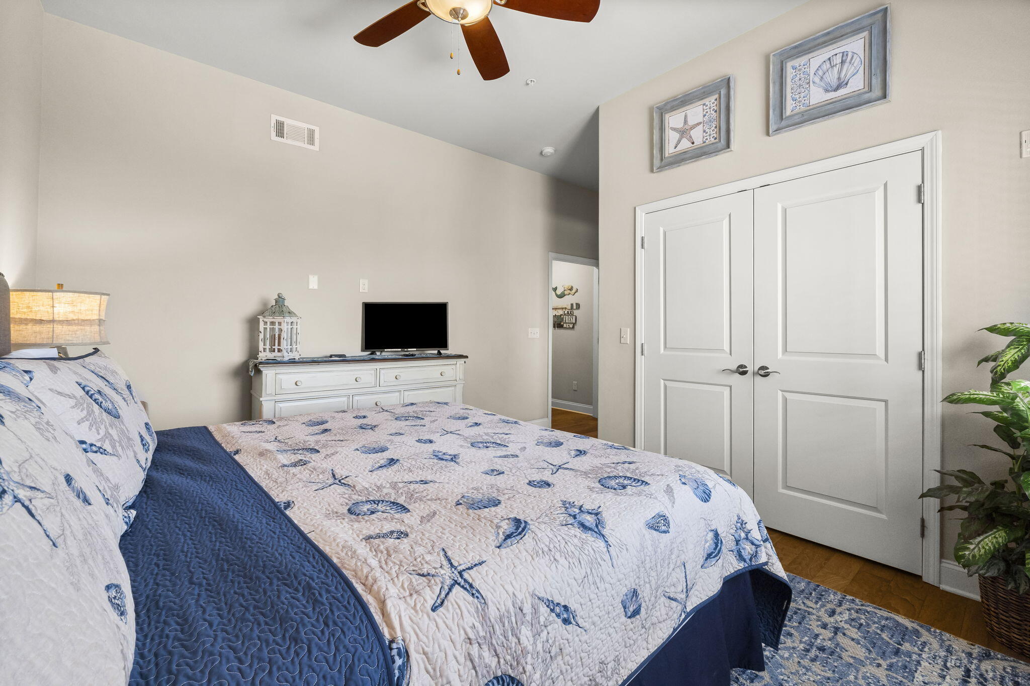 732 Scenic Gulf Drive, Unit E304 Destin, FL 32550 - Photo 9 of 34 a bedroom with a bed and wooden floor