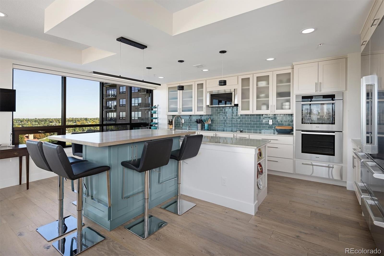 1650 Fillmore Street, Unit 1107 Denver, CO 80206 - Photo 12 of 49 a kitchen with stainless steel appliances kitchen island granite countertop a sink and cabinets