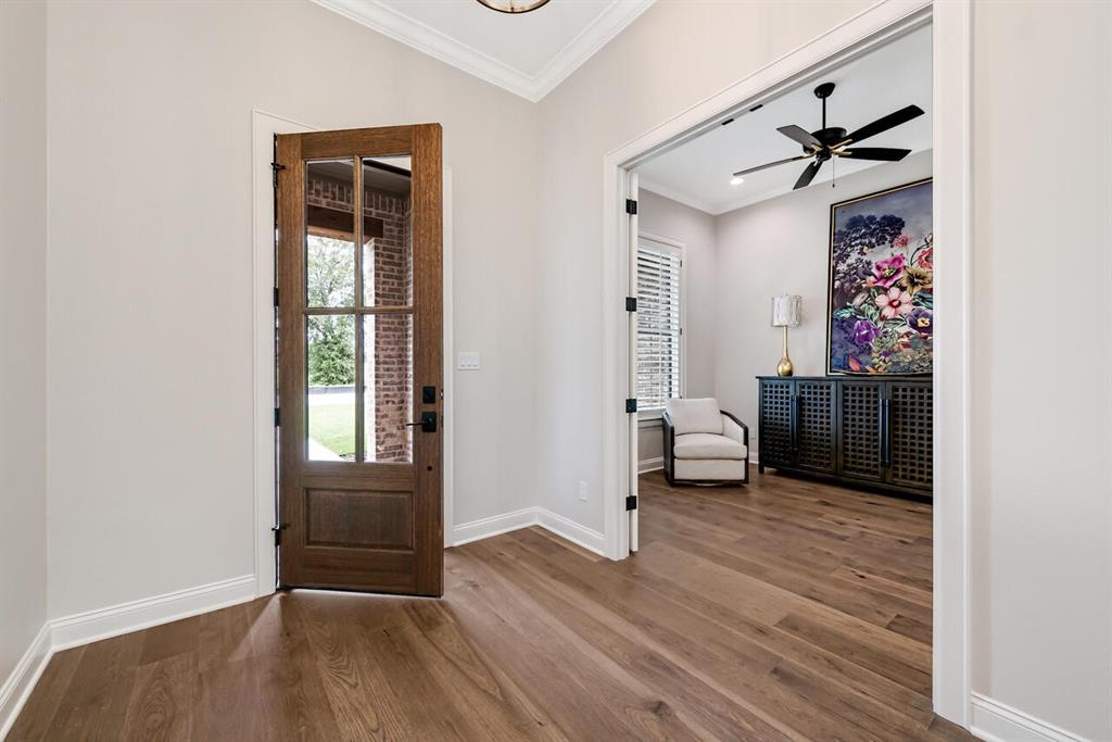 8005 Bee Cave Road China Spring, TX 76633 - Photo 8 of 40 a view of an entryway with wooden floor and a livingroom