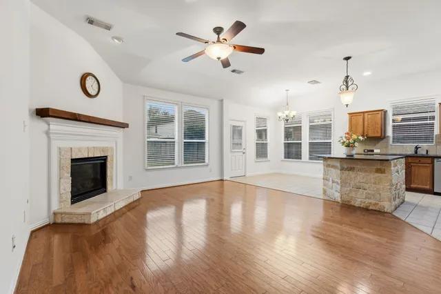 a kitchen with stainless steel appliances granite countertop a refrigerator a stove a sink and a microwave