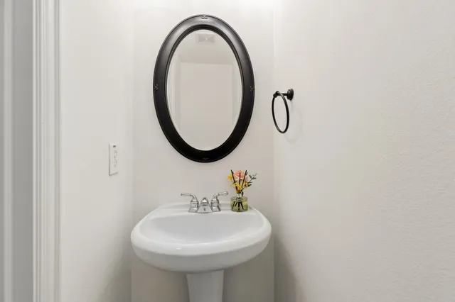 a view of an empty room with a window and a kitchen
