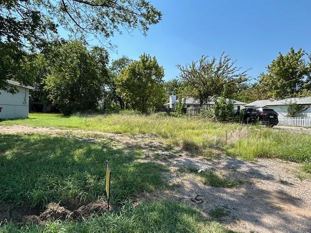 306 South Pecan Street Bells, TX 75414 - Photo 6 of 9 a backyard of a house with a yard and outdoor seating