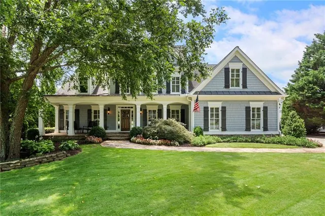 a front view of a house with a yard and outdoor seating