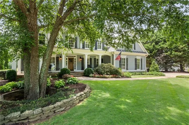 a living room with furniture a fireplace and a window