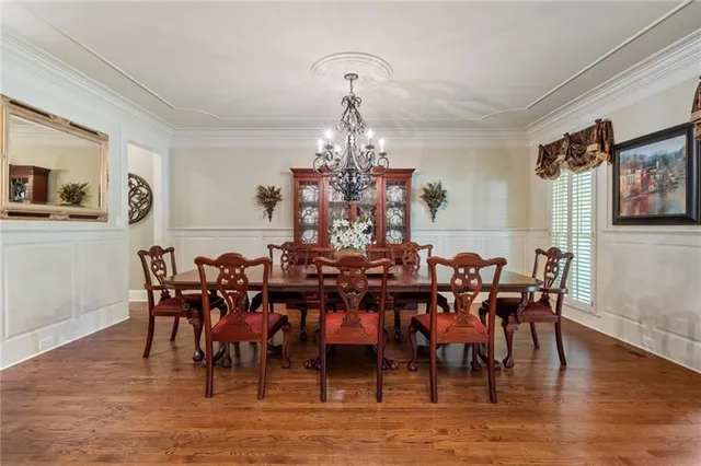 a hallway with wooden floor windows and stairs