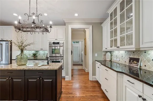 a living room with furniture a lamp and a large window