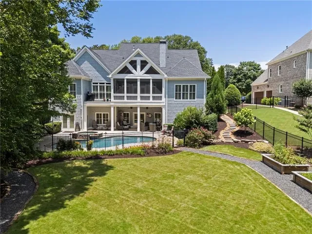 a view of a hallway with wooden floor and stairs