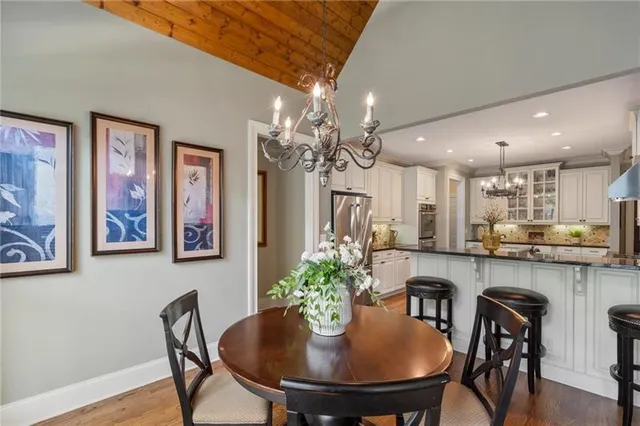 an aerial view of a house with swimming pool and large trees