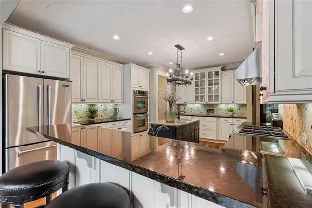 an aerial view of residential houses with outdoor space and trees