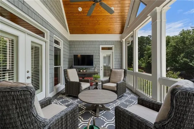 a living room with furniture a rug and a window