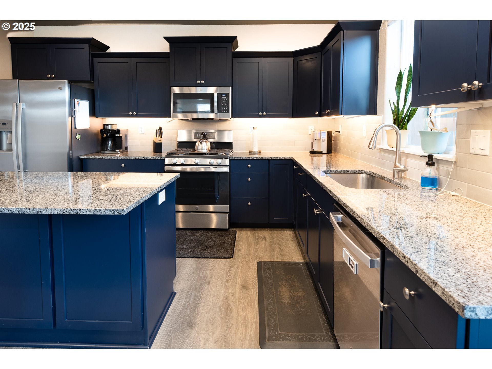 792 South 52nd Place Springfield, OR 97478 - Photo 11 of 45 a kitchen with granite countertop stainless steel appliances and wooden cabinets
