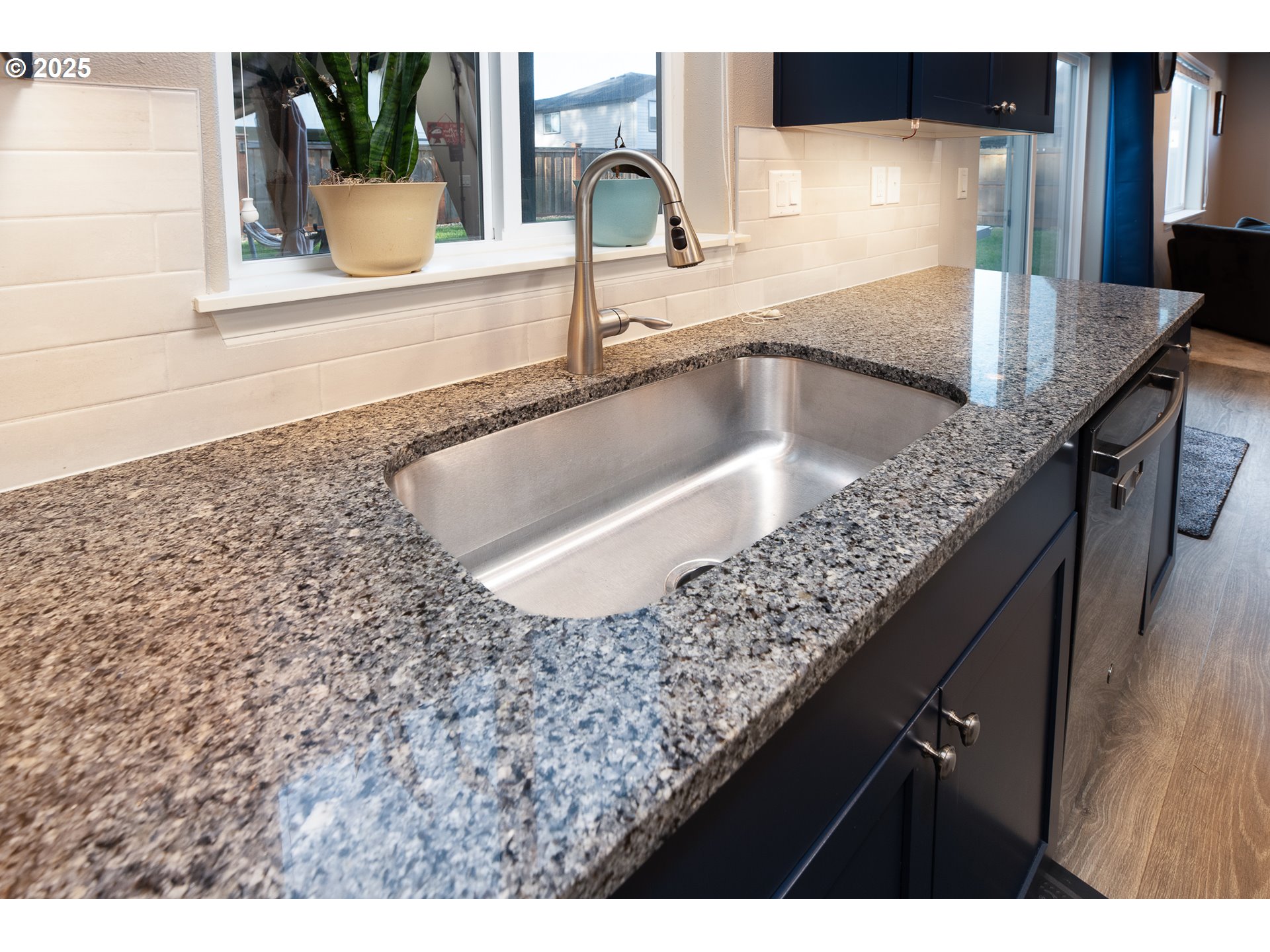 792 South 52nd Place Springfield, OR 97478 - Photo 12 of 45 a kitchen with kitchen island a sink counter top space and cabinets