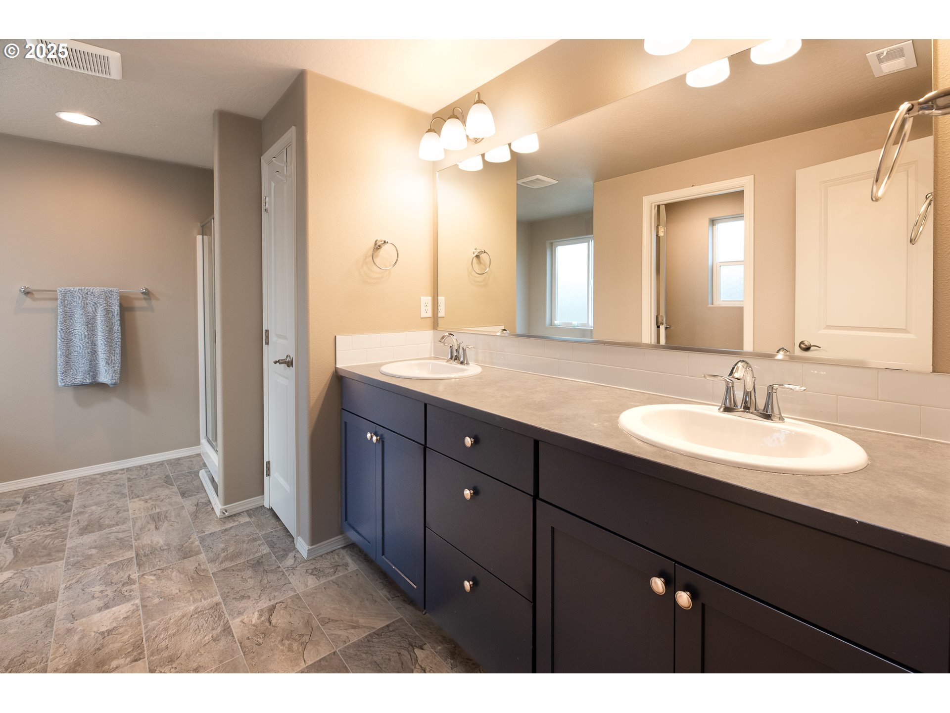 792 South 52nd Place Springfield, OR 97478 - Photo 21 of 45 a bathroom with a granite countertop sink a large mirror and a shower
