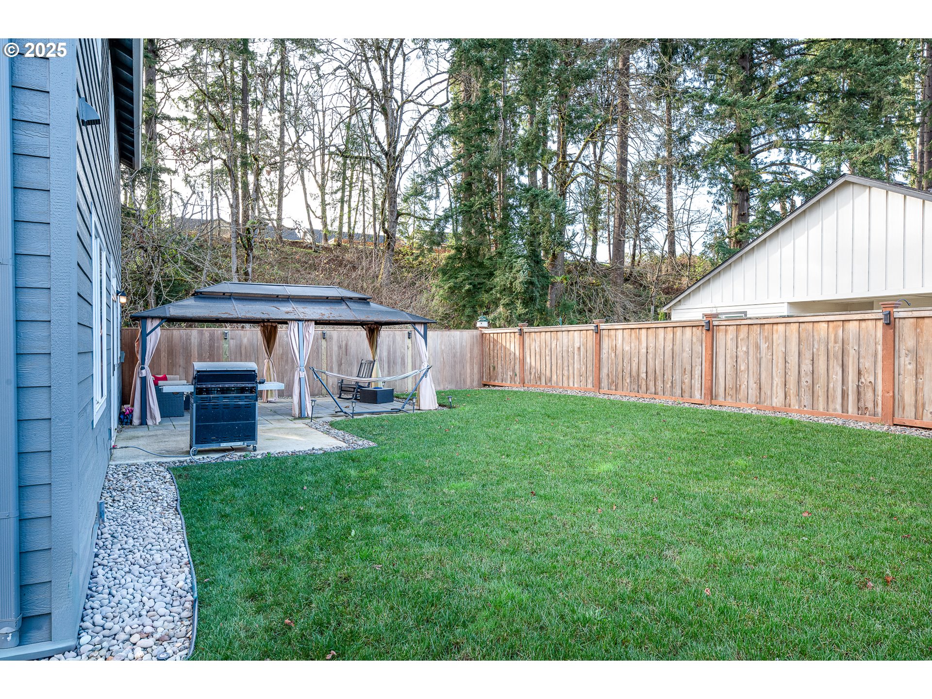 792 South 52nd Place Springfield, OR 97478 - Photo 36 of 45 a view of backyard with table and chairs and wooden fence