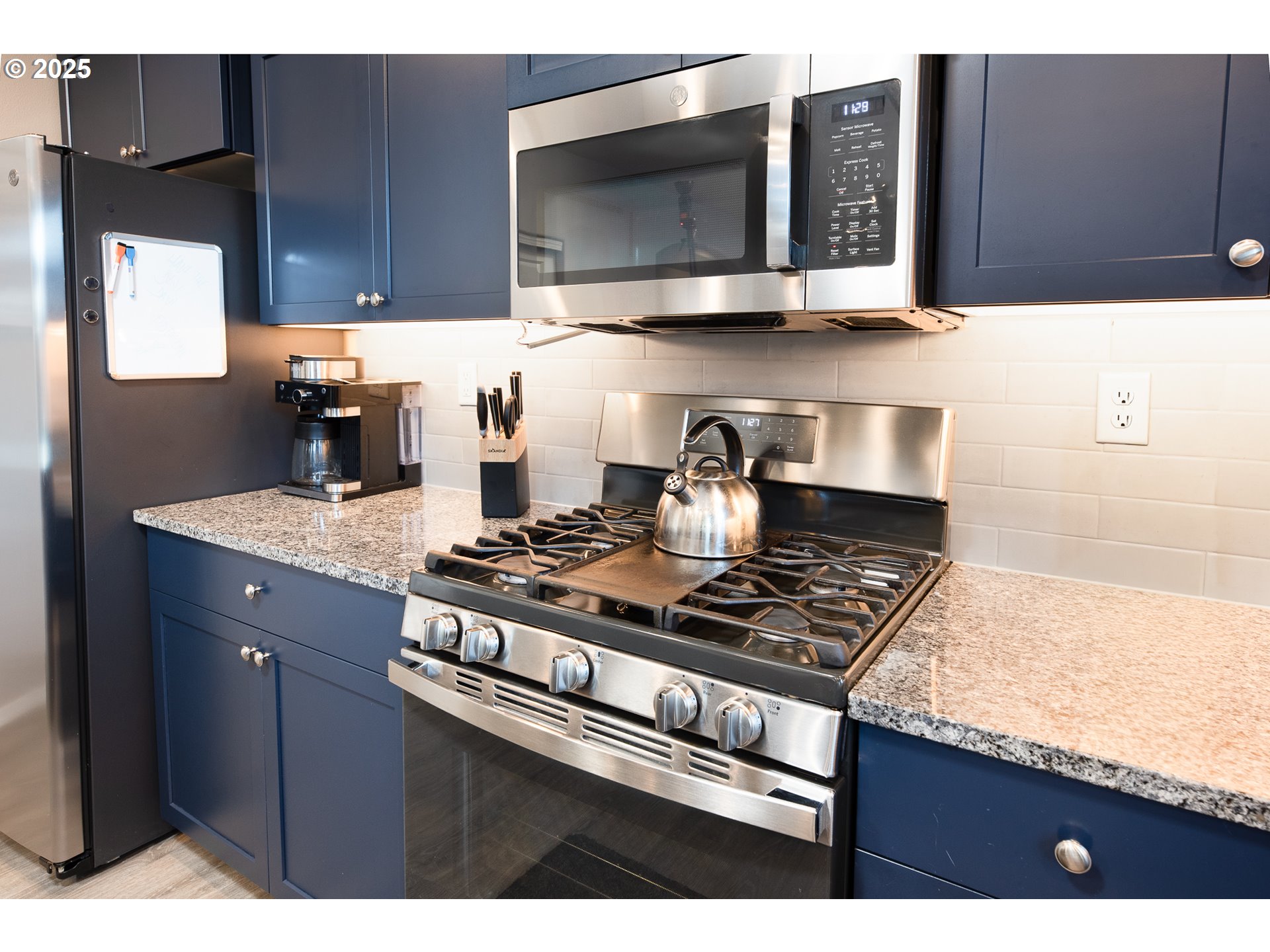 792 South 52nd Place Springfield, OR 97478 - Photo 10 of 45 a kitchen with stainless steel appliances granite countertop a stove a microwave and sink