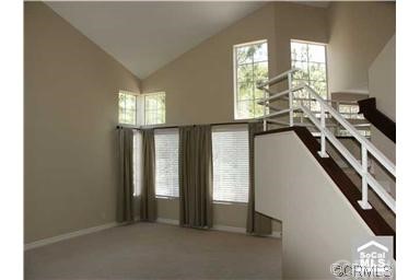LIVING ROOM AND STAIRCASE TO UPPER LEVEL