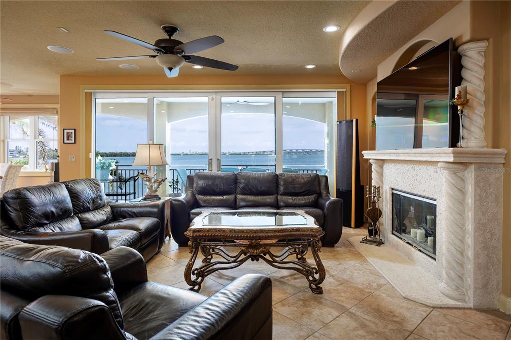 306 Harbor Drive Indian Rocks Beach, FL 33785 - Photo 11 of 58 a living room with furniture a large window and a fireplace