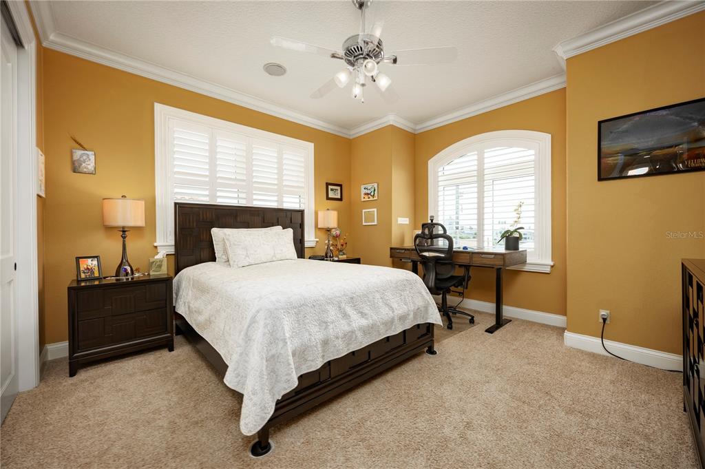 306 Harbor Drive Indian Rocks Beach, FL 33785 - Photo 29 of 58 a spacious bedroom with a bed and a chandelier