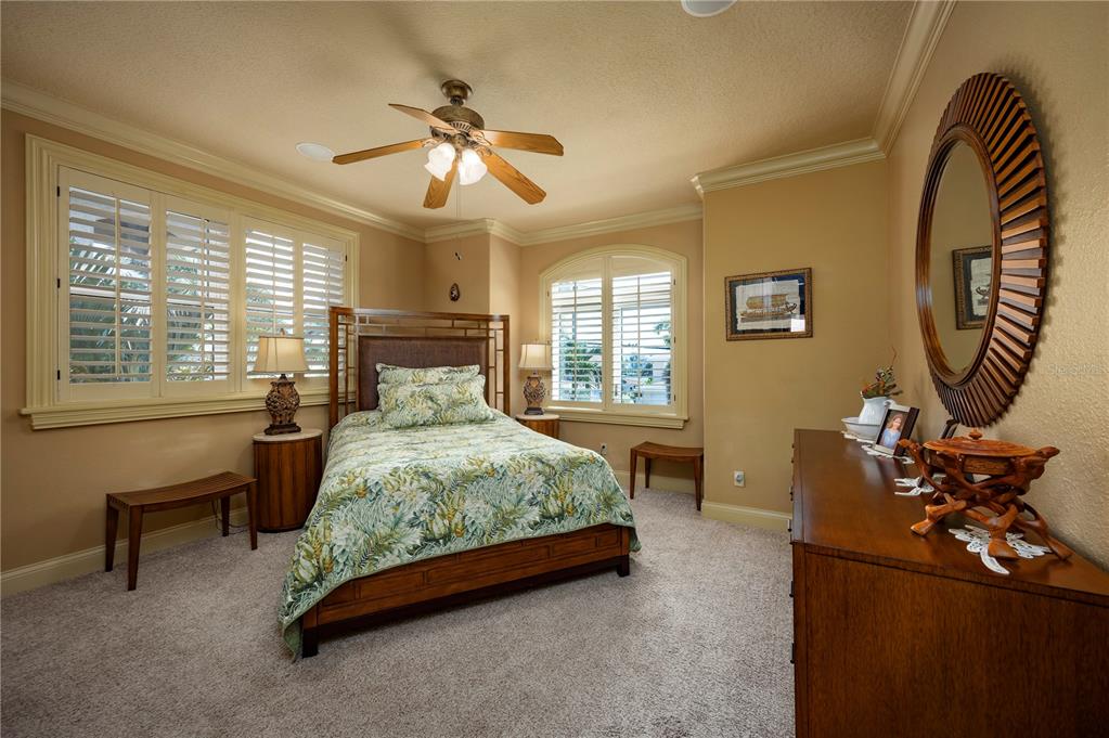 306 Harbor Drive Indian Rocks Beach, FL 33785 - Photo 34 of 58 a bed room with a bed and a chandelier