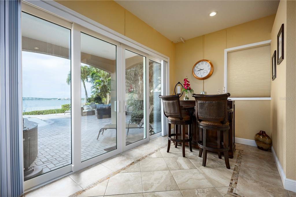 306 Harbor Drive Indian Rocks Beach, FL 33785 - Photo 50 of 58 a view of a dining room and hall with furniture