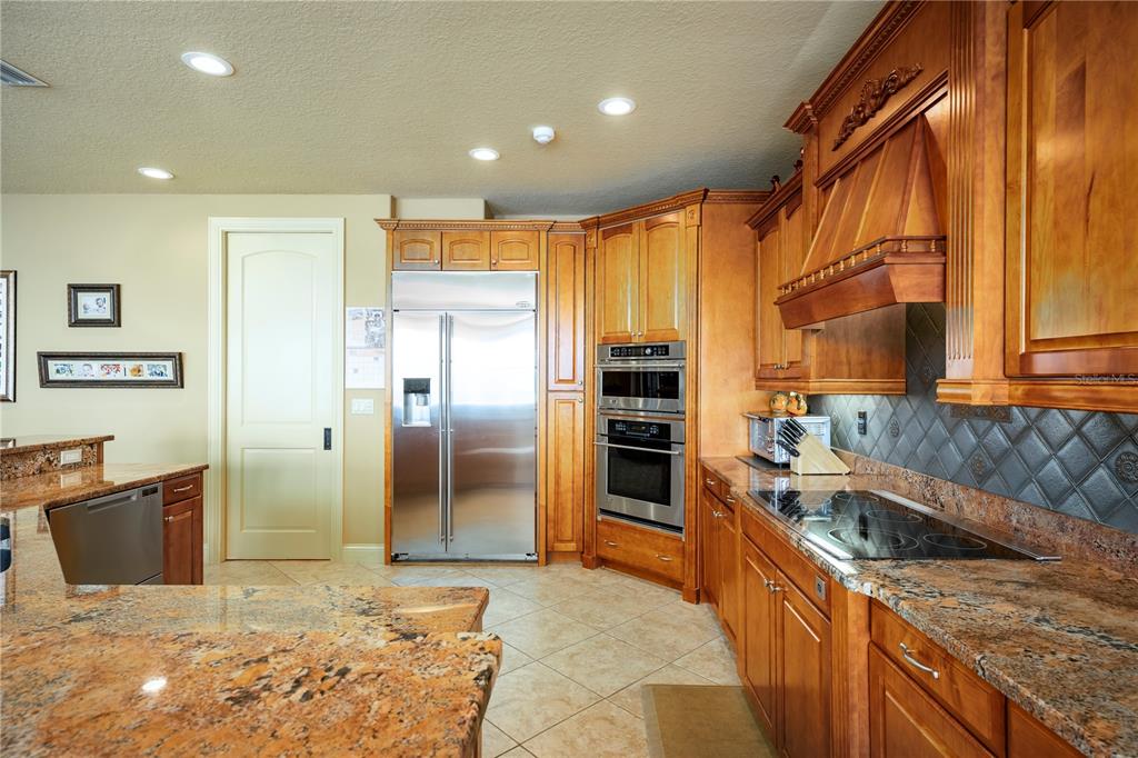 306 Harbor Drive Indian Rocks Beach, FL 33785 - Photo 5 of 58 a kitchen with stainless steel appliances granite countertop a sink and cabinets