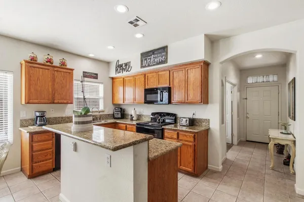 a kitchen with a sink a stove and cabinets