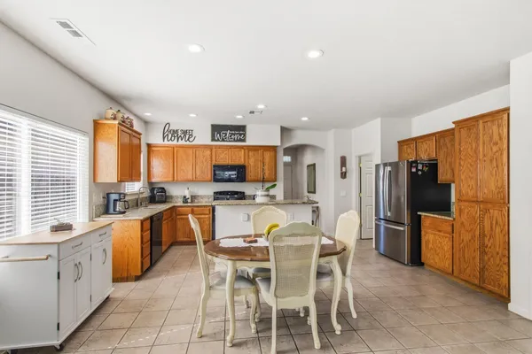 a large kitchen with a table and chairs