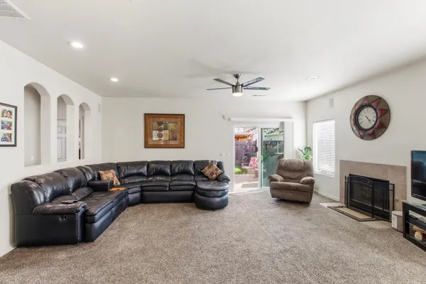 a living room with furniture a fireplace and a flat screen tv