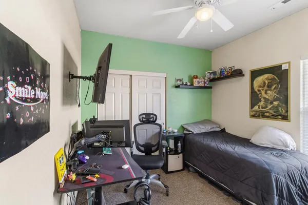 a bedroom with furniture and a painting