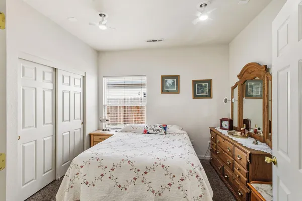 a bedroom with a bed and a dresser