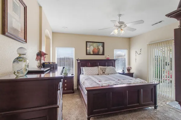 a bedroom with a large bed and a chandelier