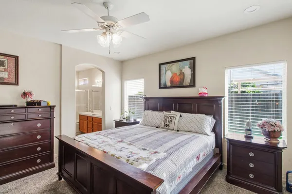 a bedroom with a bed and a dresser