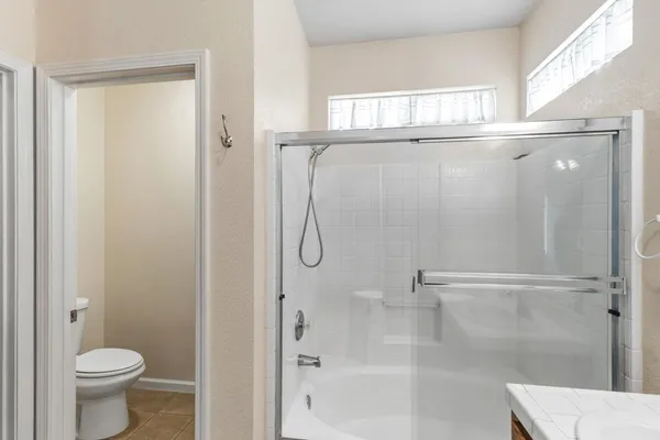 a bathroom with a glass shower door