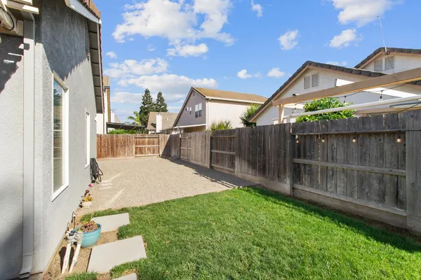 a backyard of a house with wooden floor and fence