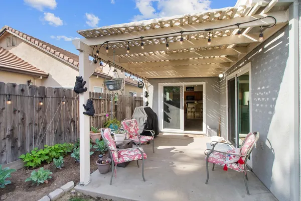a patio with patio couch and chairs