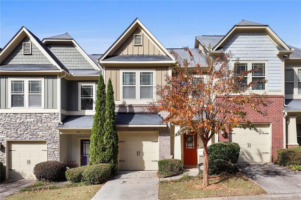 1059 North Village Drive Decatur, GA 30032 - Photo 1 of 1 a front view of a house with a yard and garage