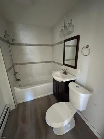 a bathroom with a toilet a sink and bathtub