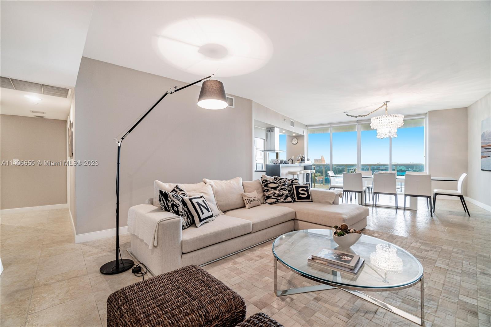 400 Alton Road, Unit 611 Miami Beach, FL 33139 - Photo 8 of 27 a living room with furniture a rug and a chandelier