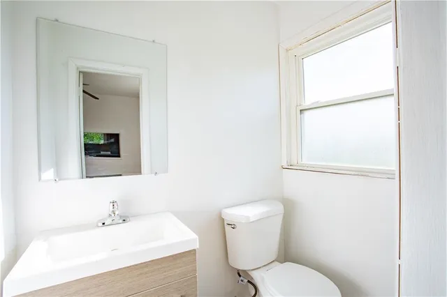 a white toilet sitting next to a bathroom sink