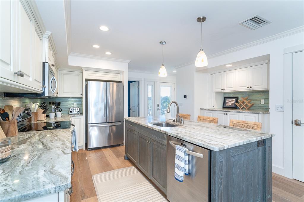 301 South Gulf Boulevard, Unit 25 Placida, FL 33946 - Photo 12 of 68 a kitchen with stainless steel appliances granite countertop a sink a stove and a refrigerator