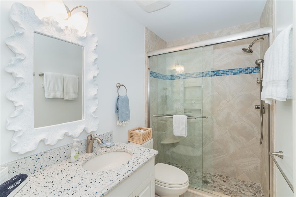 301 South Gulf Boulevard, Unit 25 Placida, FL 33946 - Photo 31 of 68 a bathroom with a granite countertop sink mirror toilet and shower