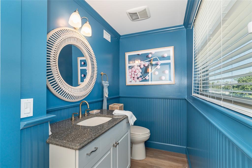 301 South Gulf Boulevard, Unit 25 Placida, FL 33946 - Photo 6 of 68 a bathroom with a granite countertop toilet a sink and a mirror