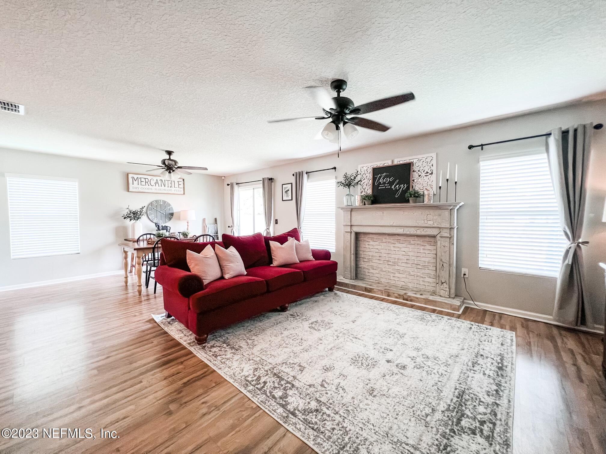 45190 Dutton Way Callahan, FL 32011 - Photo 11 of 29 a living room with furniture and a fireplace
