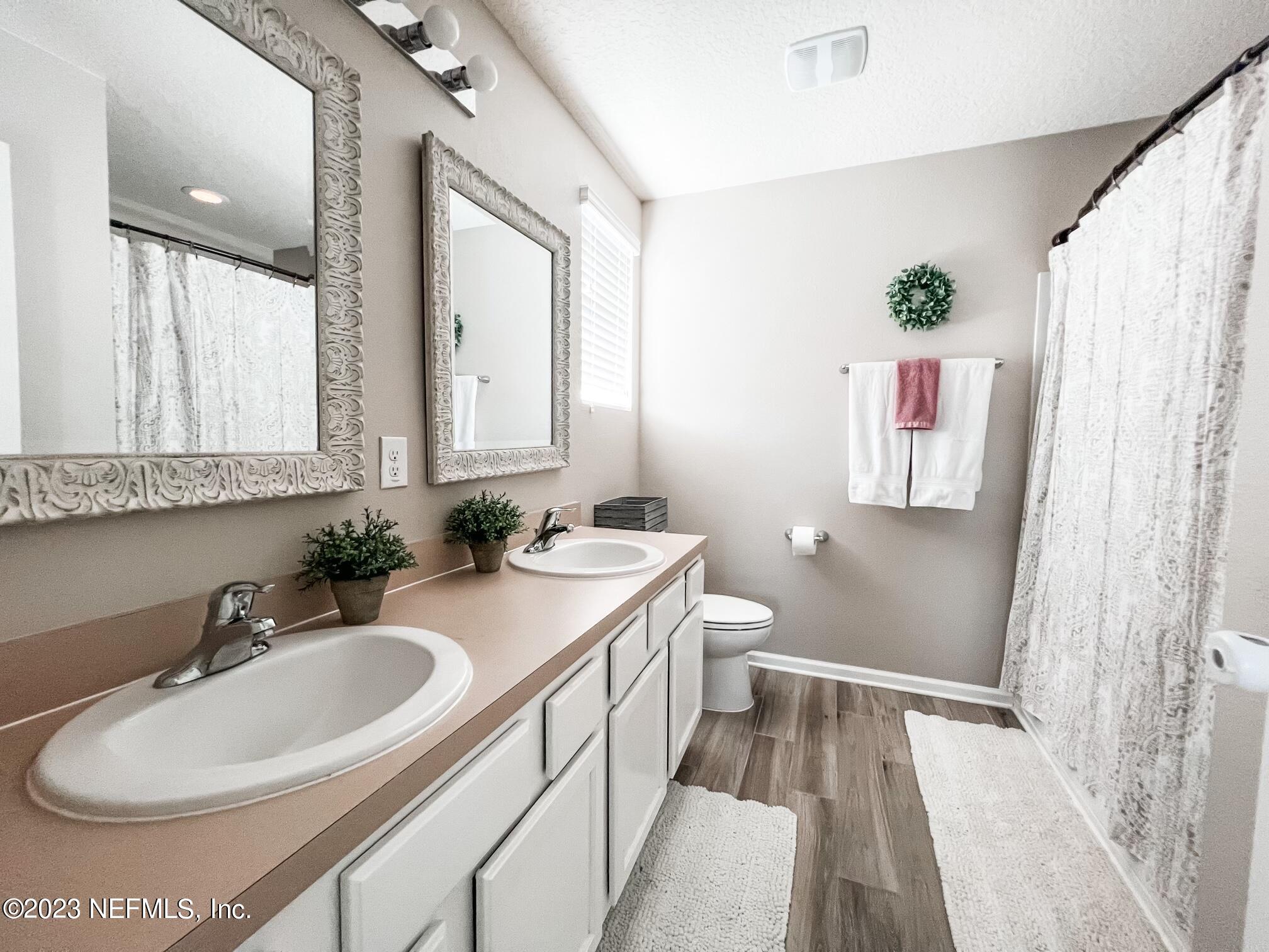 45190 Dutton Way Callahan, FL 32011 - Photo 22 of 29 a bathroom with a sink and a mirror